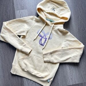 TNA woman’s Hoodie Size XS Butter Yellow with Purple Logo, excellent condition